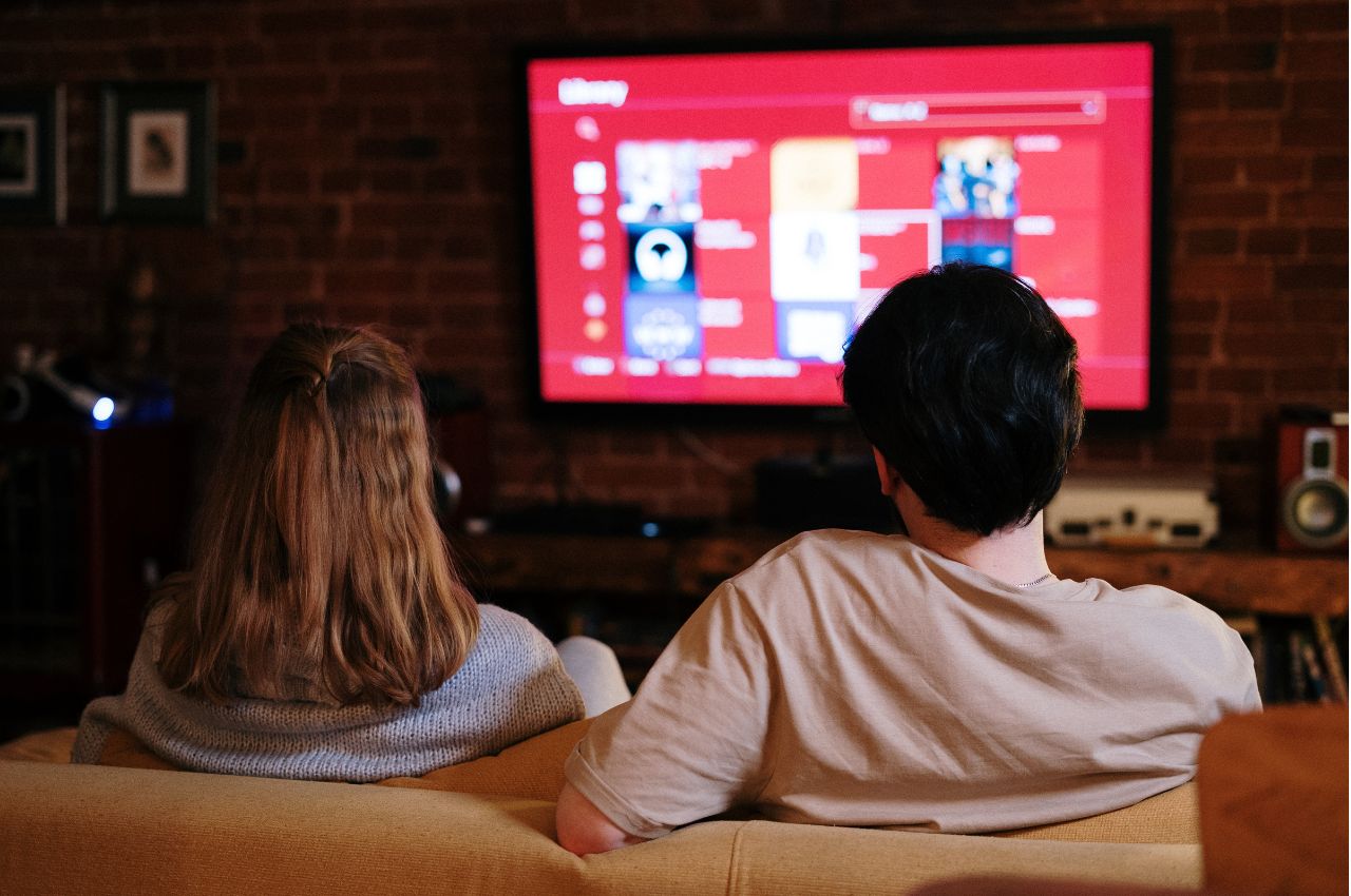 People sitting on the couch watching tv